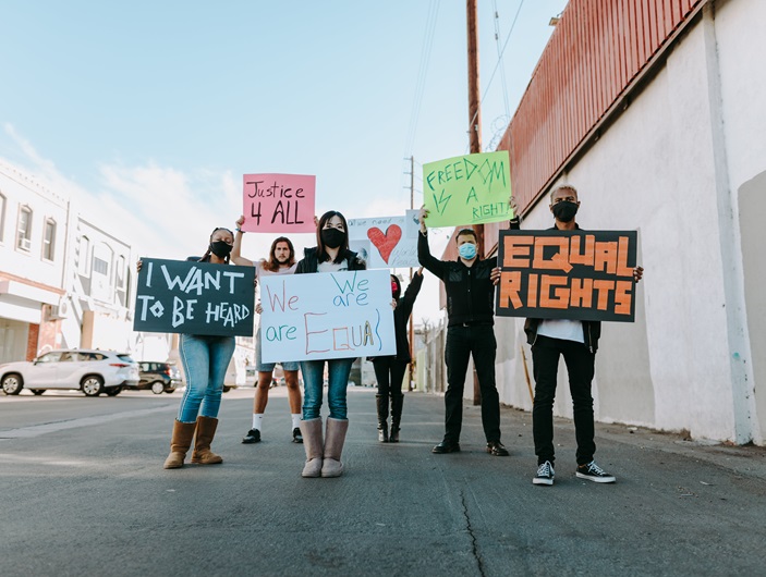 Several people are standing on a street with posters in their hands that say "Equal Rights", for example ©RDNE Stock project - www.pexels.com