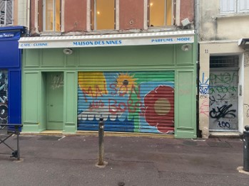Maison des Nines in Noailles, its shutter graffitoed “Maison des Bobos.” 