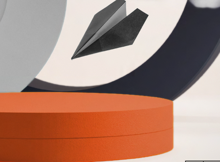 Papierflieger in Schwarz, Ringe in Orange und Schwarz ©bitte Urheberangaben hinterlegen