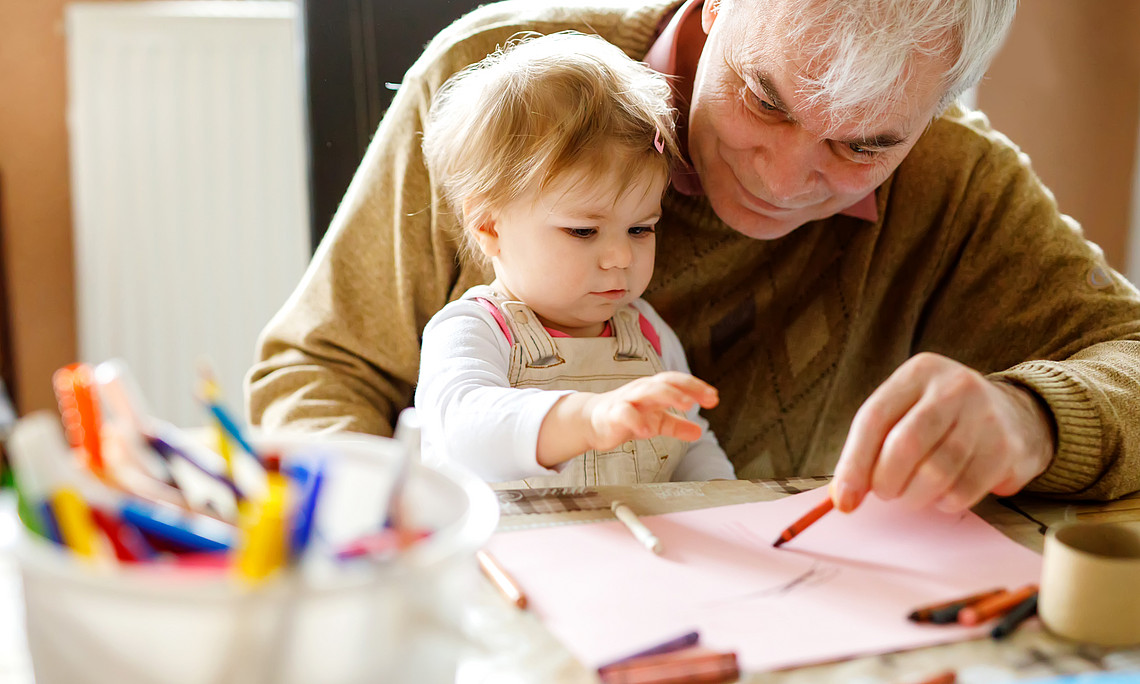 old person taking care of child symbolizing care