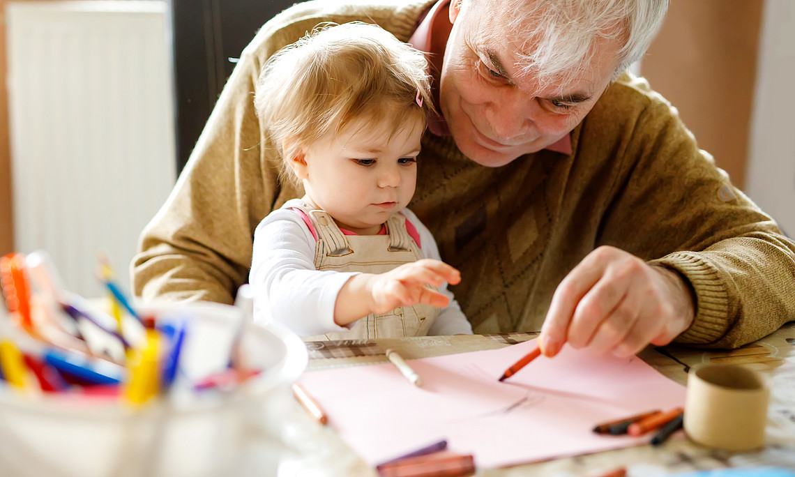elderly person cares about a young kid