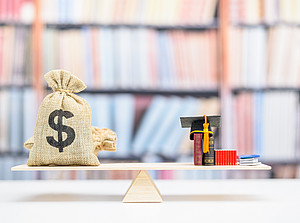 A bag of money and a doctor's hat on a scale in front of a bookshelf 