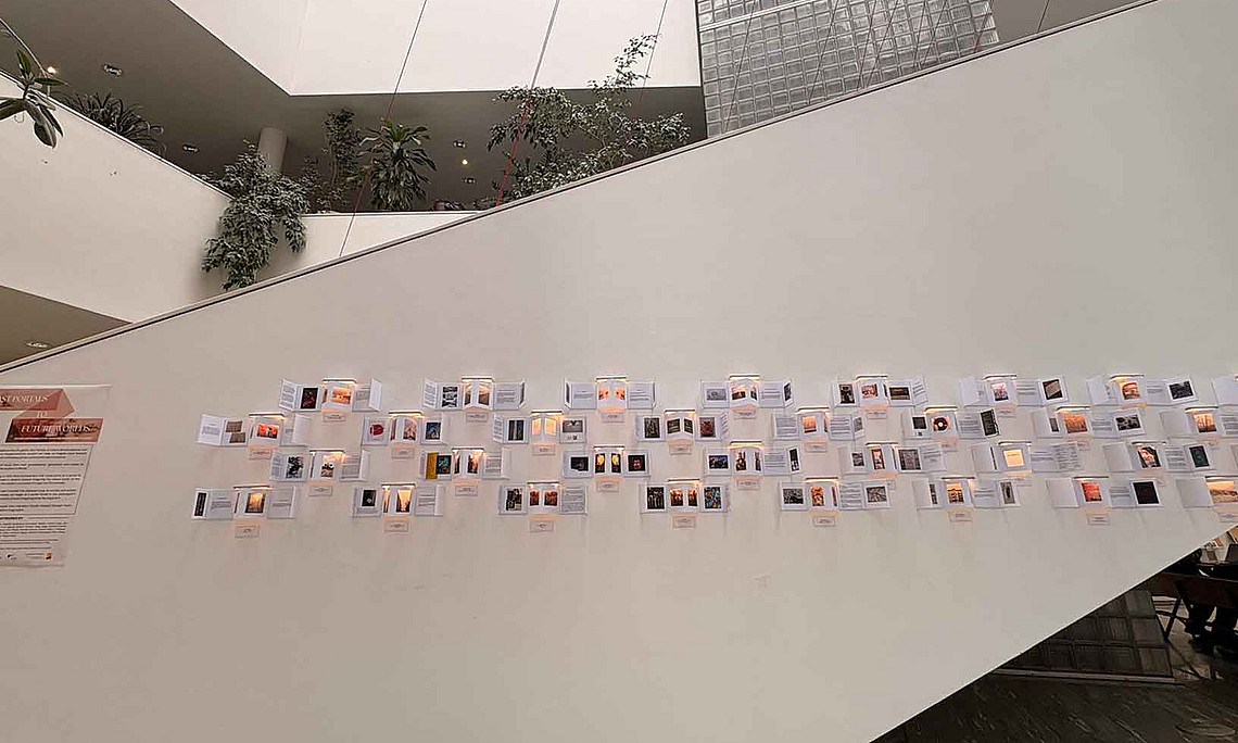 Auf einer Wand sind Fotos und Texte angebracht.