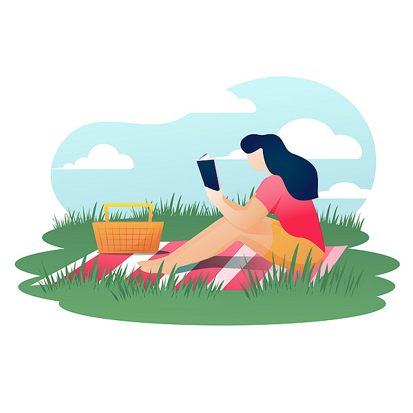 Person liest auf Picknickdecke aus einer Buchempfehlung