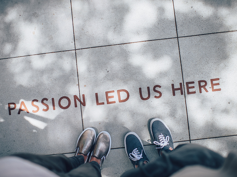 passion led us here written on asphalt ©Photo by Ian Schneider on Unsplash