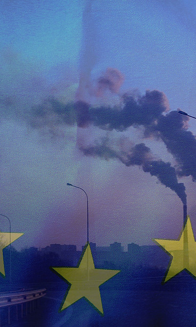 Smoke from chimneys in front of EU flag