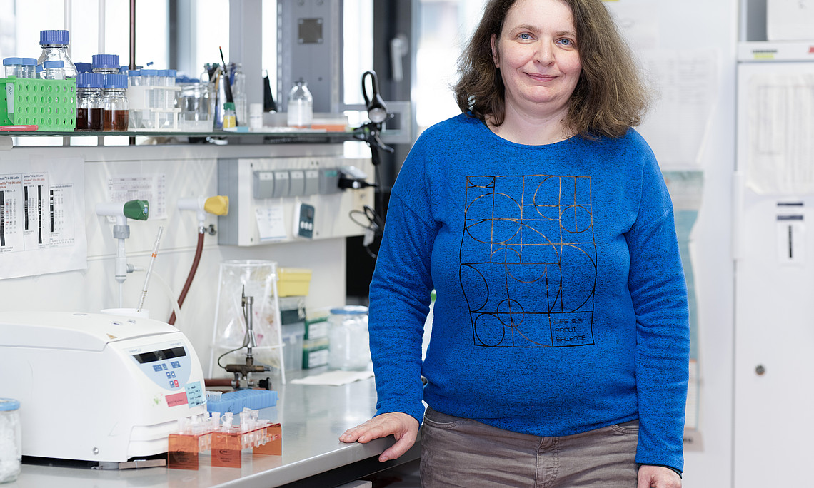 A woman stands in a lab