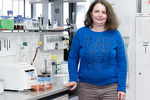 A woman stands in a lab
