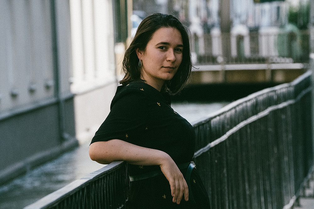 Portrait of Natalija Milovanović, leaning against the side of a bridge railing 