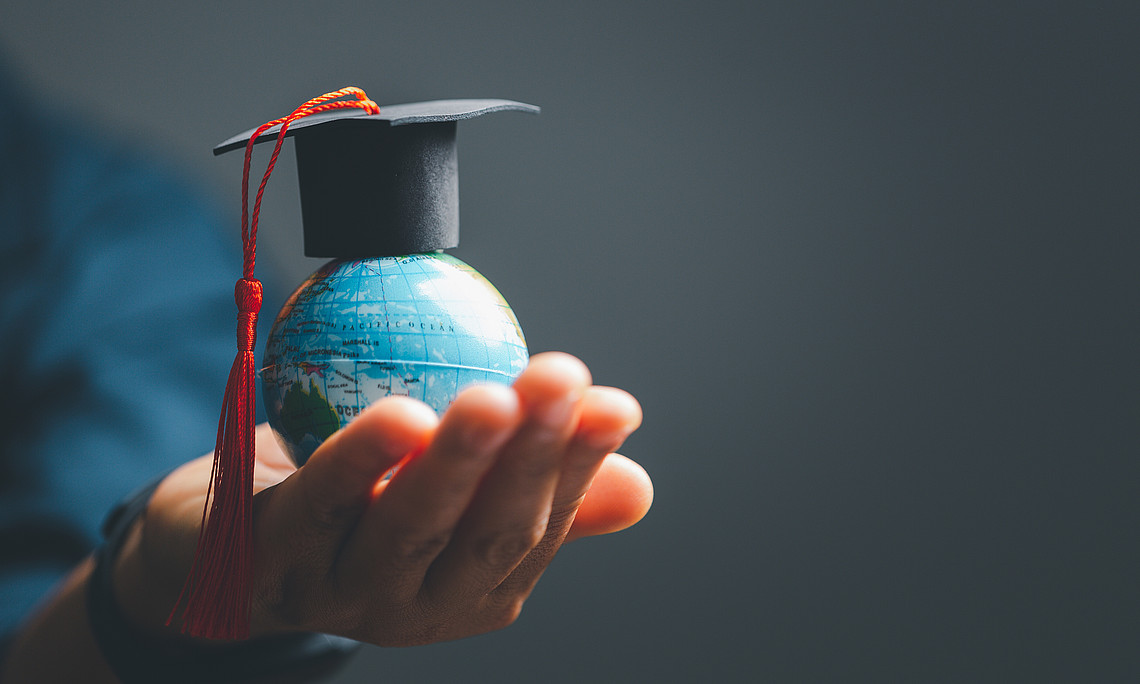 Graduation cap with Earth globe. Concept of global business study, abroad educational, Back to School. Education in Global world, Study abroad business in universities in worldwide. 