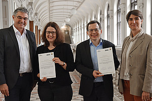 Joachim Reidl, Christine Schwanecke, Sandro Keller and Mireille van Poppel in the corridor in front of the auditorium of the University of Graz