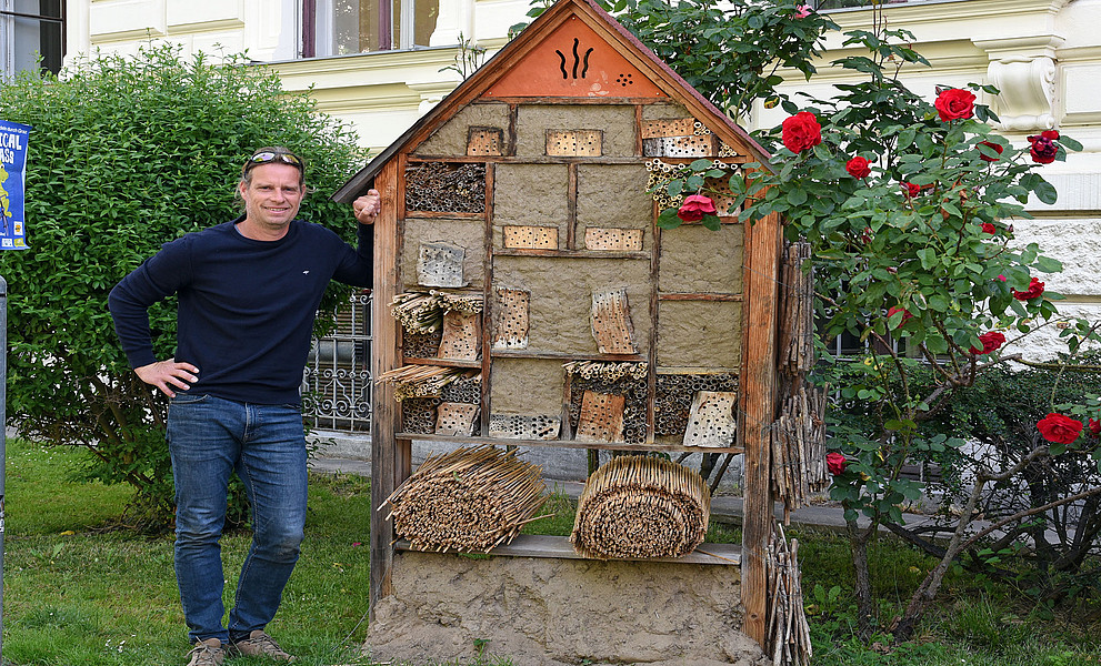 Biologe Gernot Kunz neben dem von ihm gestalteten Insektenhotel am Campus der Uni Graz