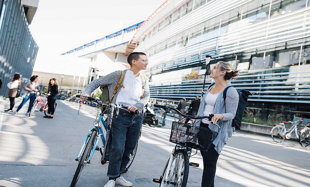 zwei Studentinnen mit Fahrrad