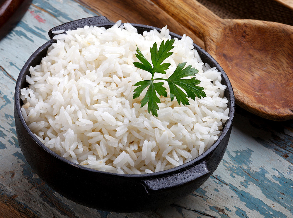 Eine Schüssel Reis mit einem Holzlöffel ©lcrribeiro33@gmail - stock.adobe.com