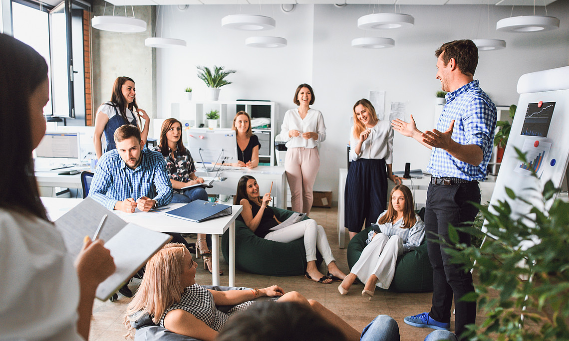 A creative working group works together on new innovative business models. Modern, open office space in a relaxed and upbeat atmosphere.