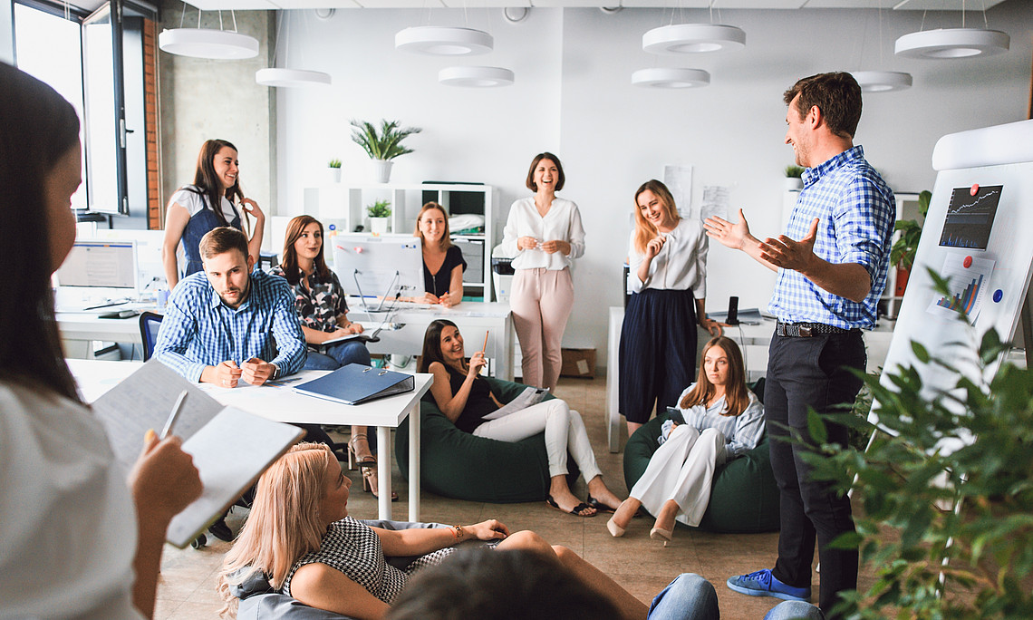 A creative working group works together on new innovative business models. Modern, open office space in a relaxed and upbeat atmosphere.