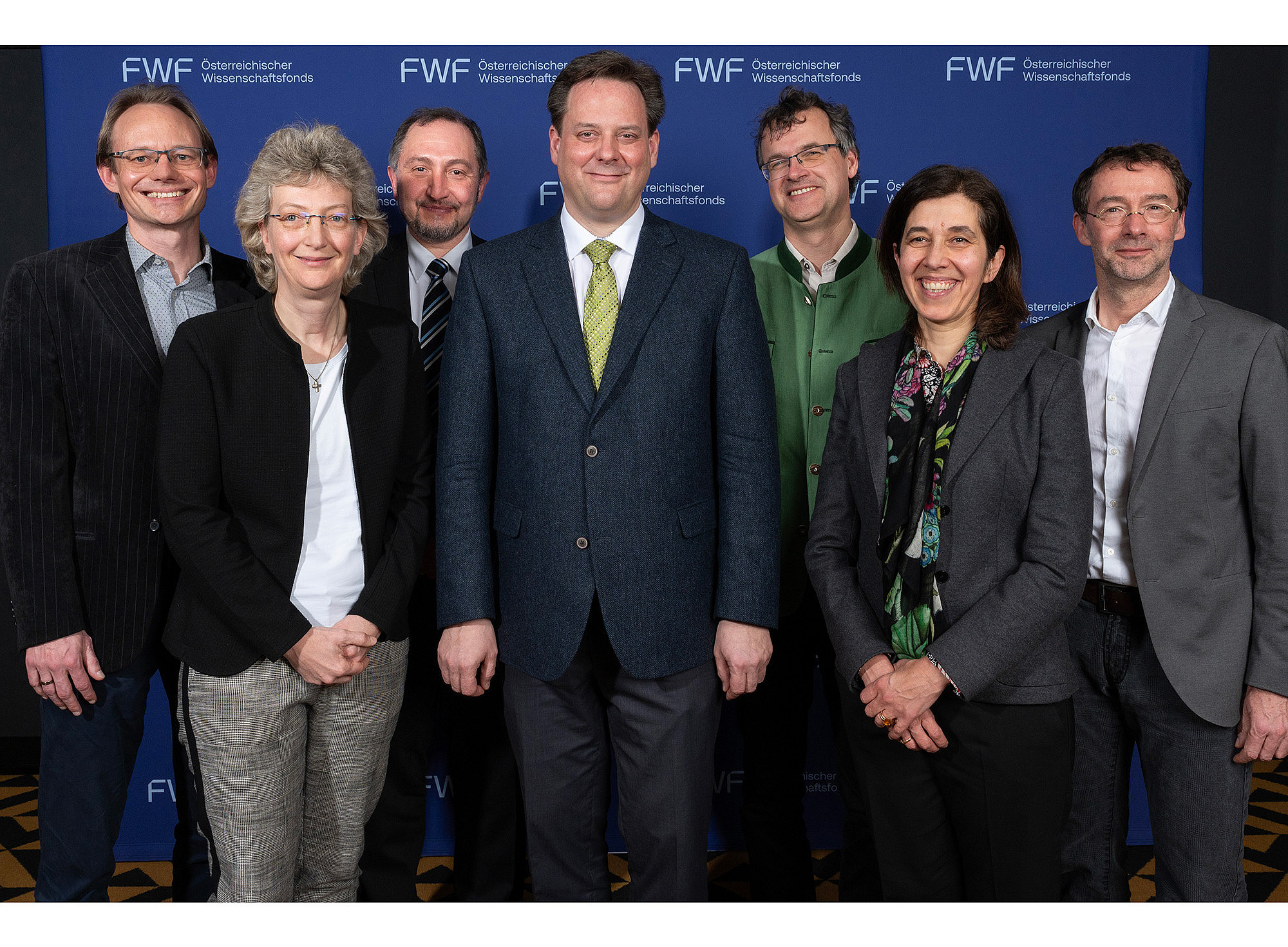 Group photo of the Board of Directors of the Cluster of Excellence Circular Bioengineering, with the FWF logo on the wall in the background ©FWF/Daniel Novotny