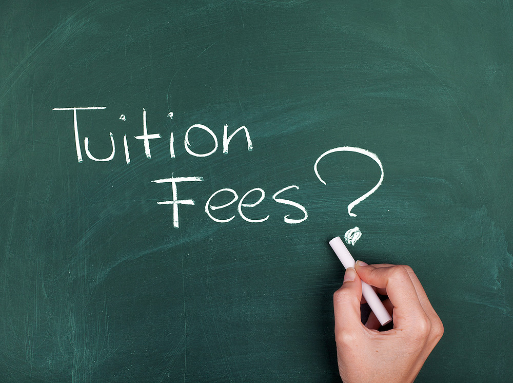 the word tuition fees written on a chalkboard ©By OdetaBlue; stock.adobe.com 