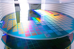 A close-up image of a semiconductor wafer with etched grids during the fabrication process