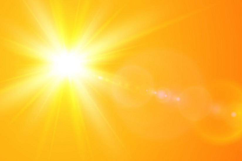 yellow, radiant sun in front of orange background