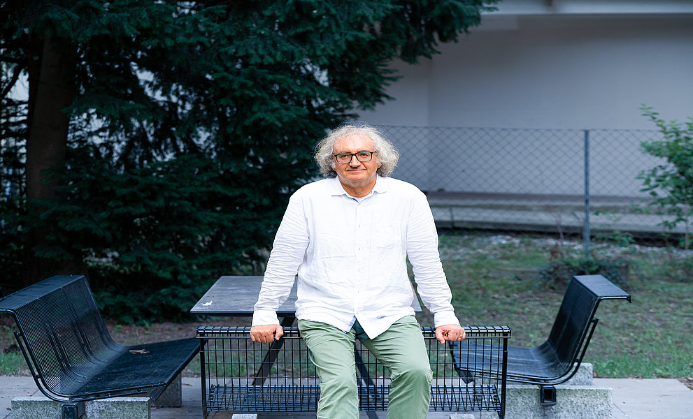 Ein Mann lehnt an einer Parkbank