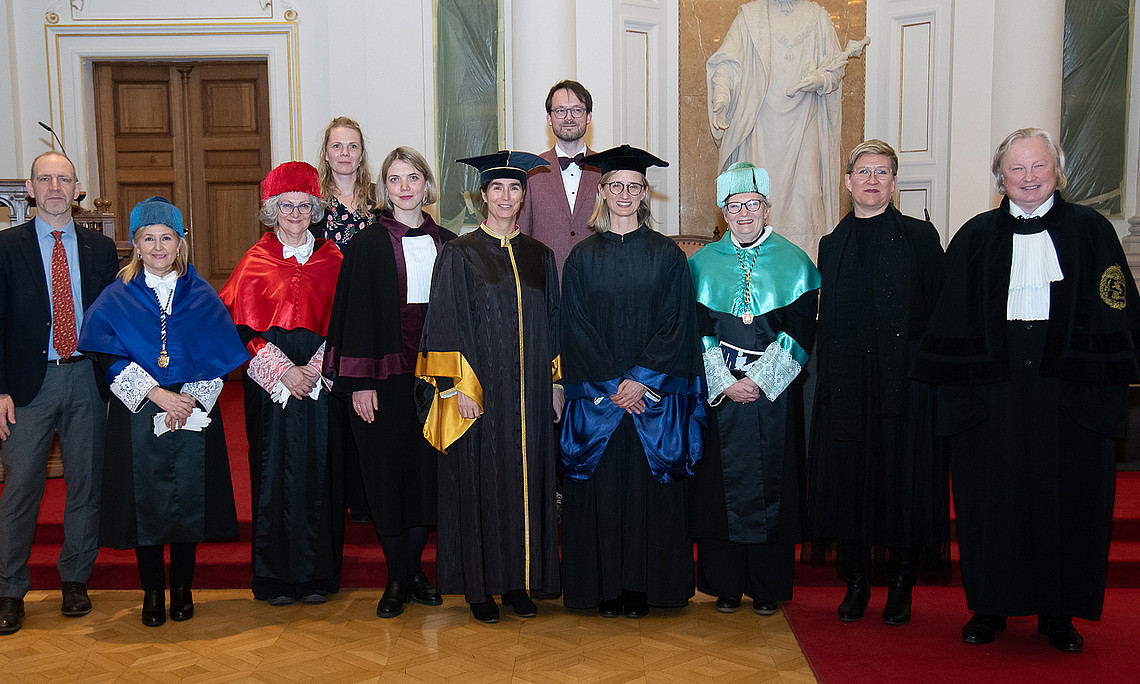 Group photo of university representatives in the Aula
