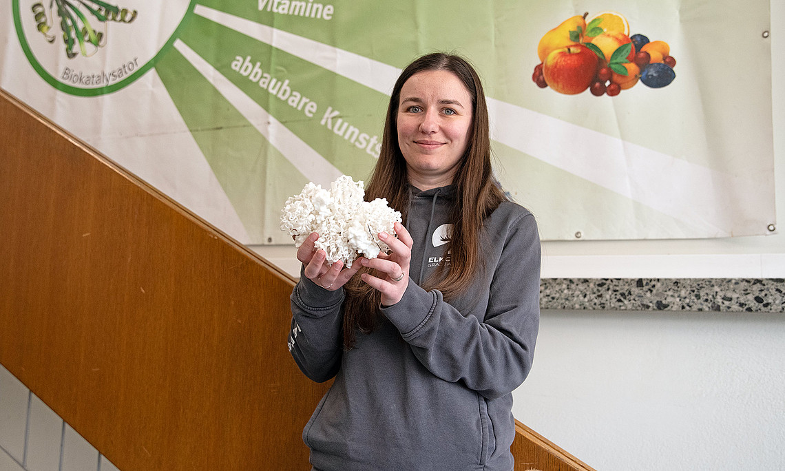 Lilla Gal holds a model of the enzyme she discovered