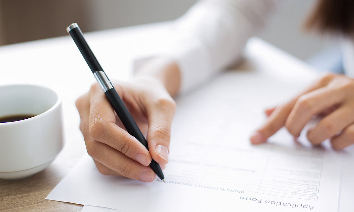 closeup of applicant completing application form