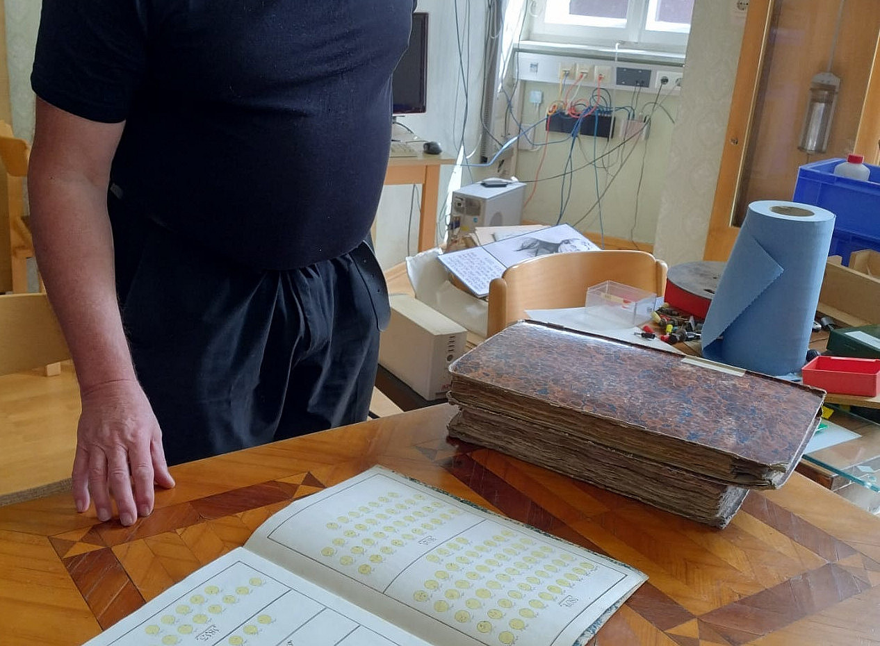 Monk Pater Amand (director of the observatory) opens the archives for us, here showing solar observations that started with hand-written reports and drawing of sunspots from the 18th century at the monastery Kremsmünster. [Photo: Manuela Temmer] ©Uni Graz/Bourdin