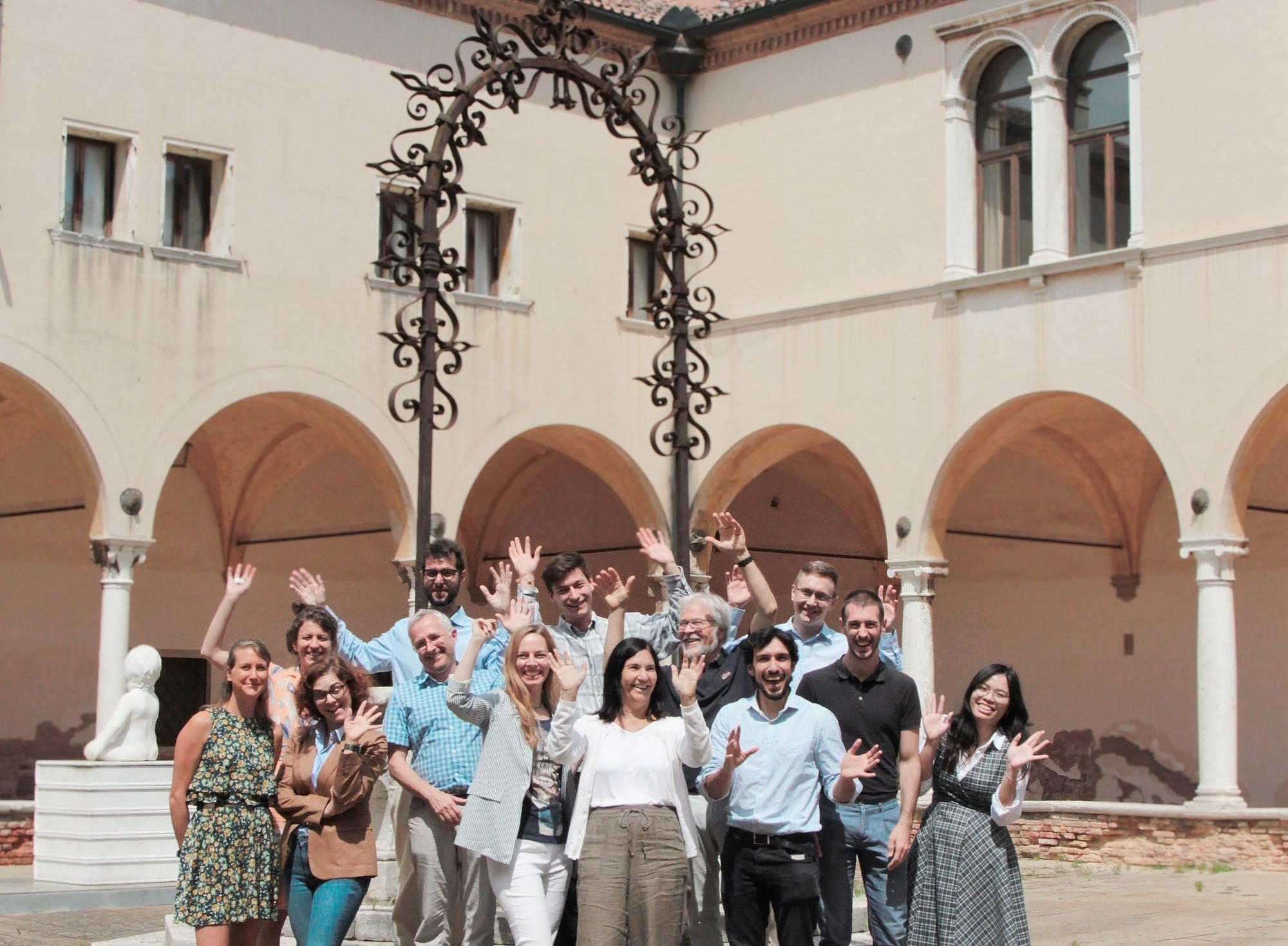 Participants of the doctoral programme on the Global Campus on Lido, cheering and holding up their hands ©Global Campus