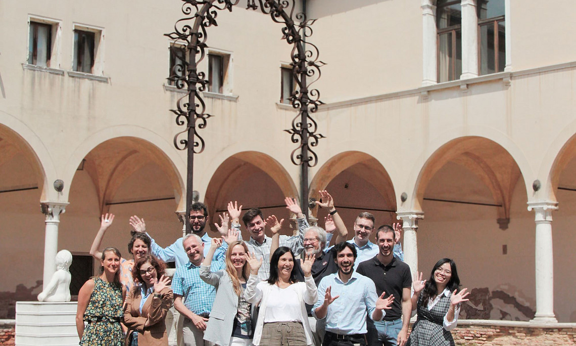 Participants of the doctoral programme on the Global Campus on Lido, cheering and holding up their hands