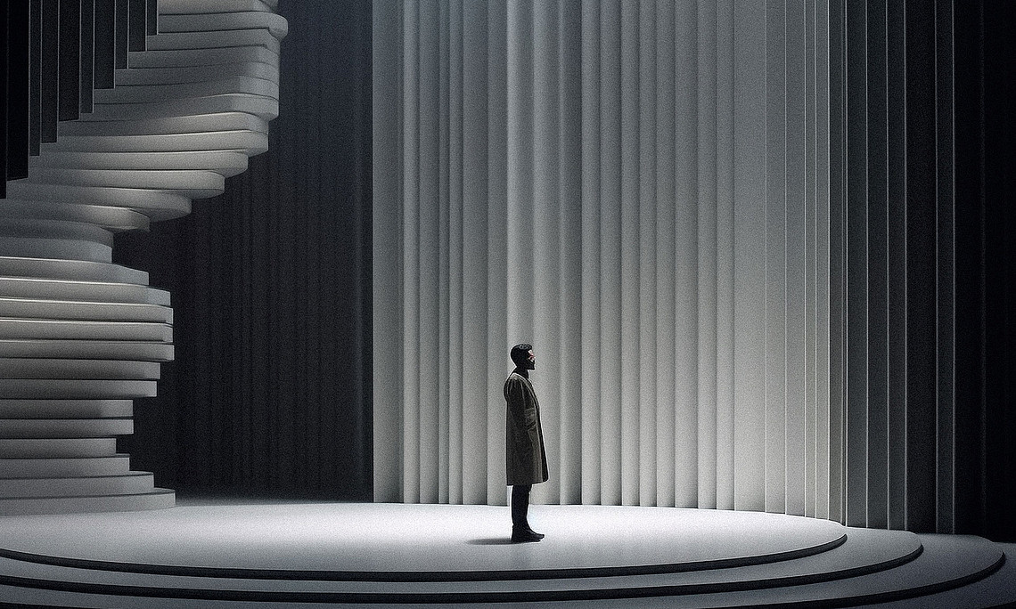 Man standing on a platform, at the back left a staircase leads upwards