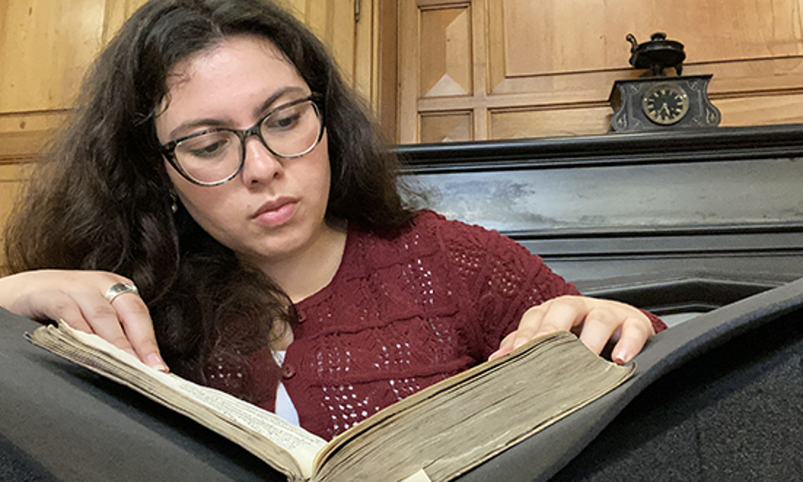 Frau mit Locken schaut in ein Buch