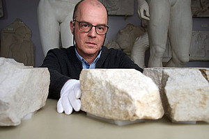 Archaeologist Stephan Karl joins two fragments of an altar slab together