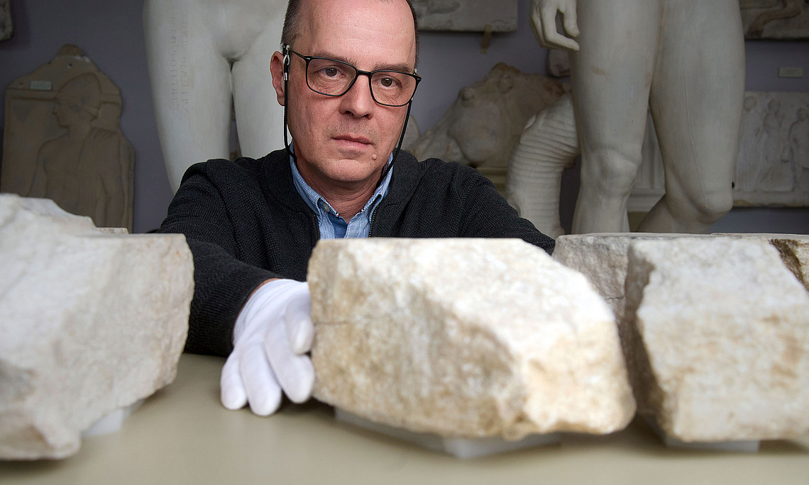 Archaeologist Stephan Karl joins two fragments of an altar slab together