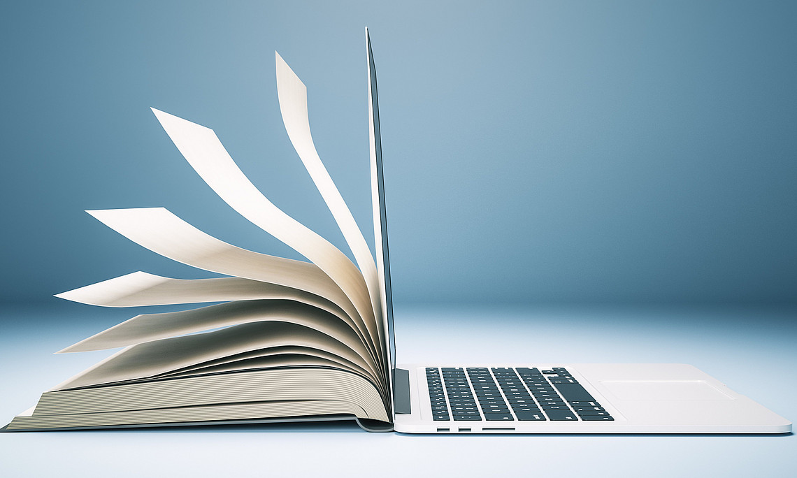 Darstellung von einem Buch und einem Laptop