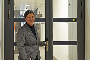 Pharmacognosist Solveigh Koeberle in front of a door in her department