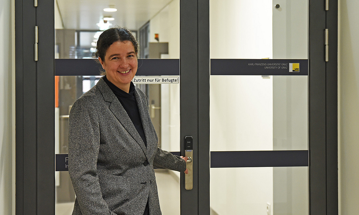 Pharmacognosist Solveigh Koeberle in front of a door in her department