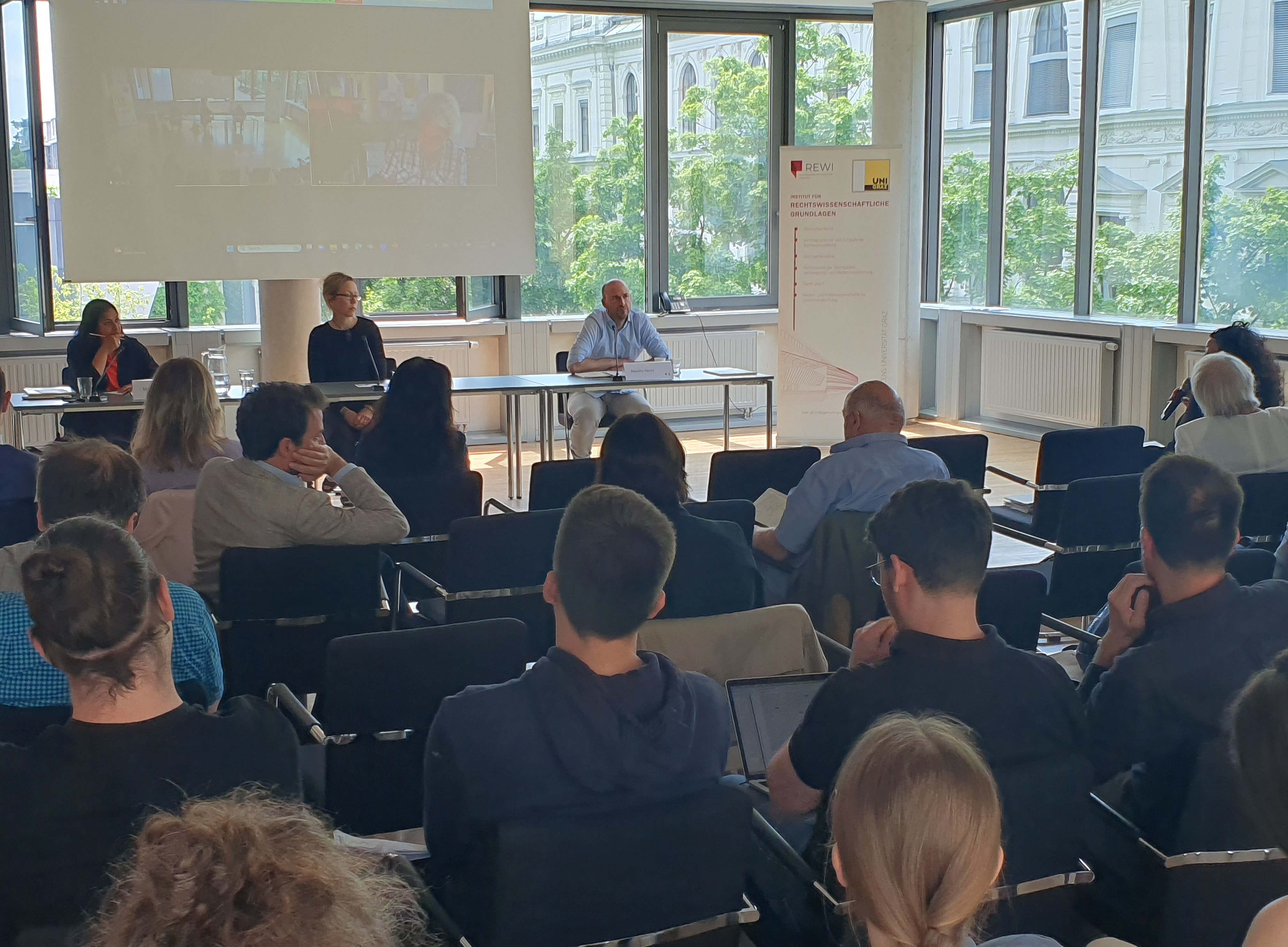Symposium "Unpacking Global Governance" panelists in front of the audience 