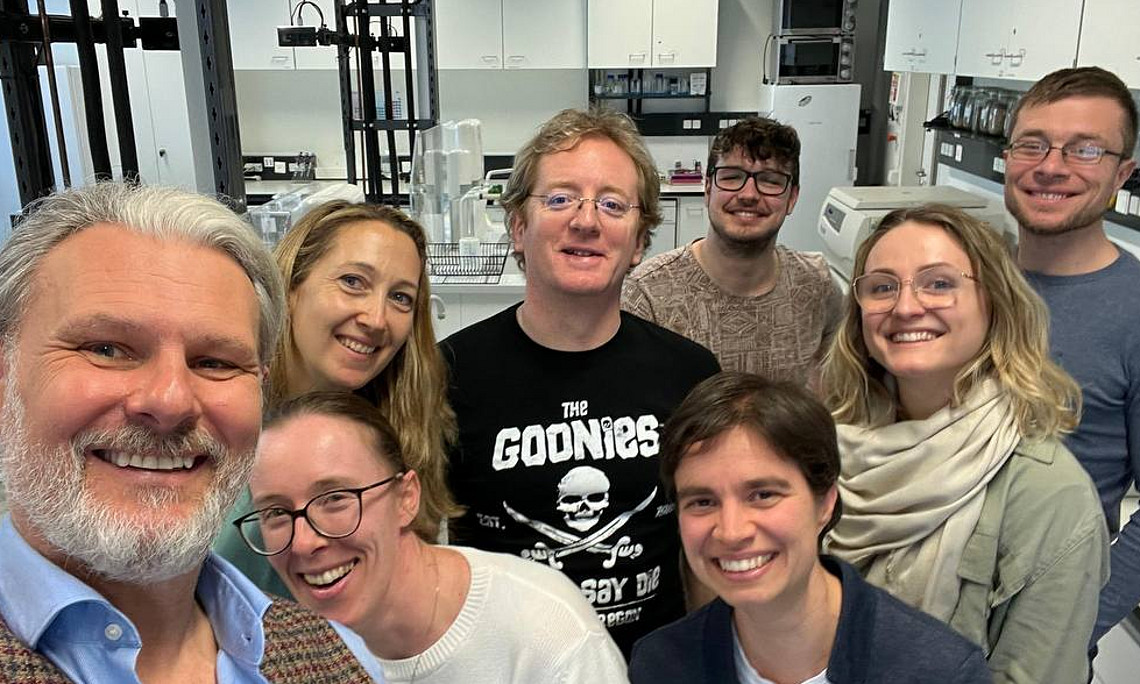 Man sieht das Team im Labor ein Selfie machen.
