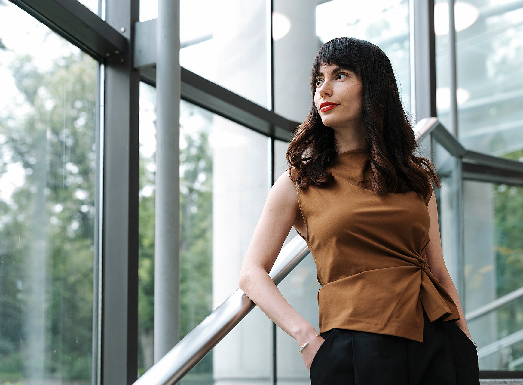 Sociologist Zorica Sirocic leans against a banister and looks to her left into the distance. ©KANIZAJ photography 2025