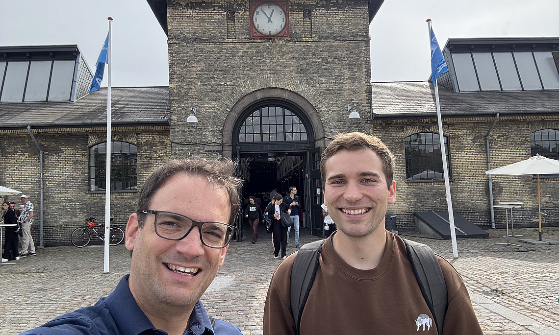 Philipp Spitzer und Sebastian Tassoti vor der Conference Venue 