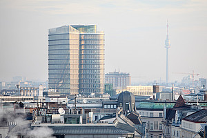 View from above of Vienna with the UNIQA Tower and the Danube Tower, haze in the air, some smoke in the foreground