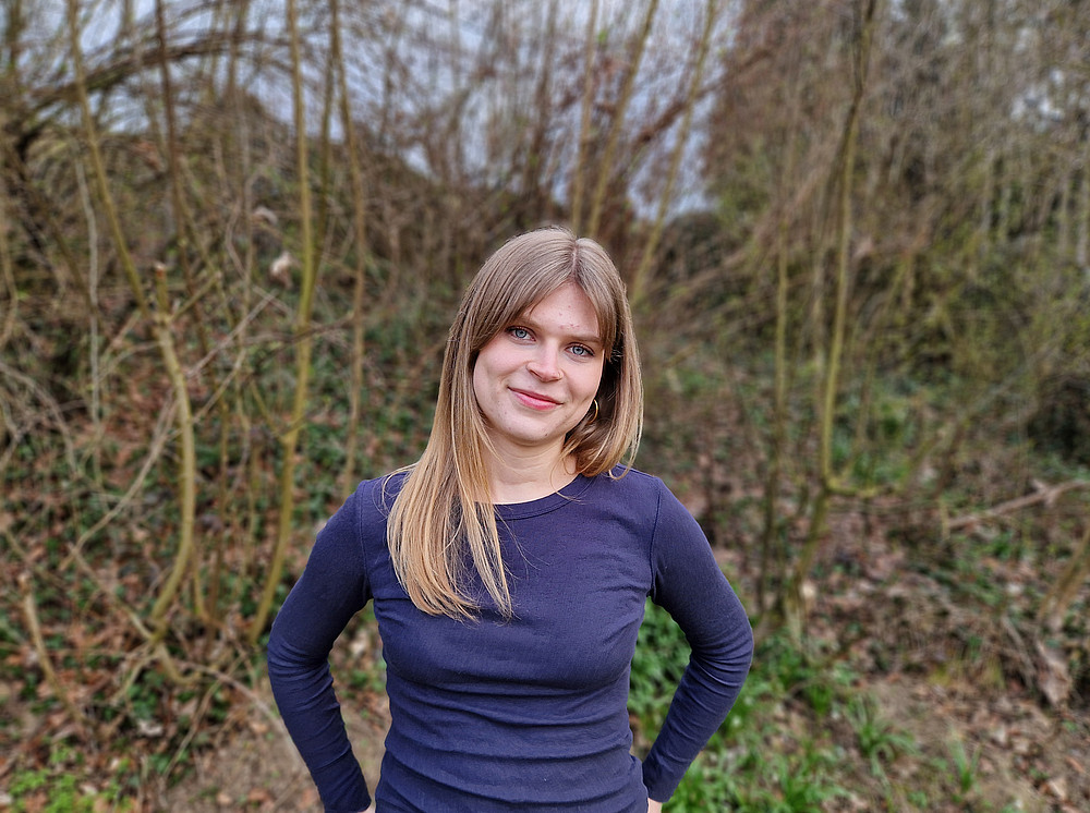 Ms Klimstein is standing in a wooded area, smiling at the camera with her hands on her hips ©privat