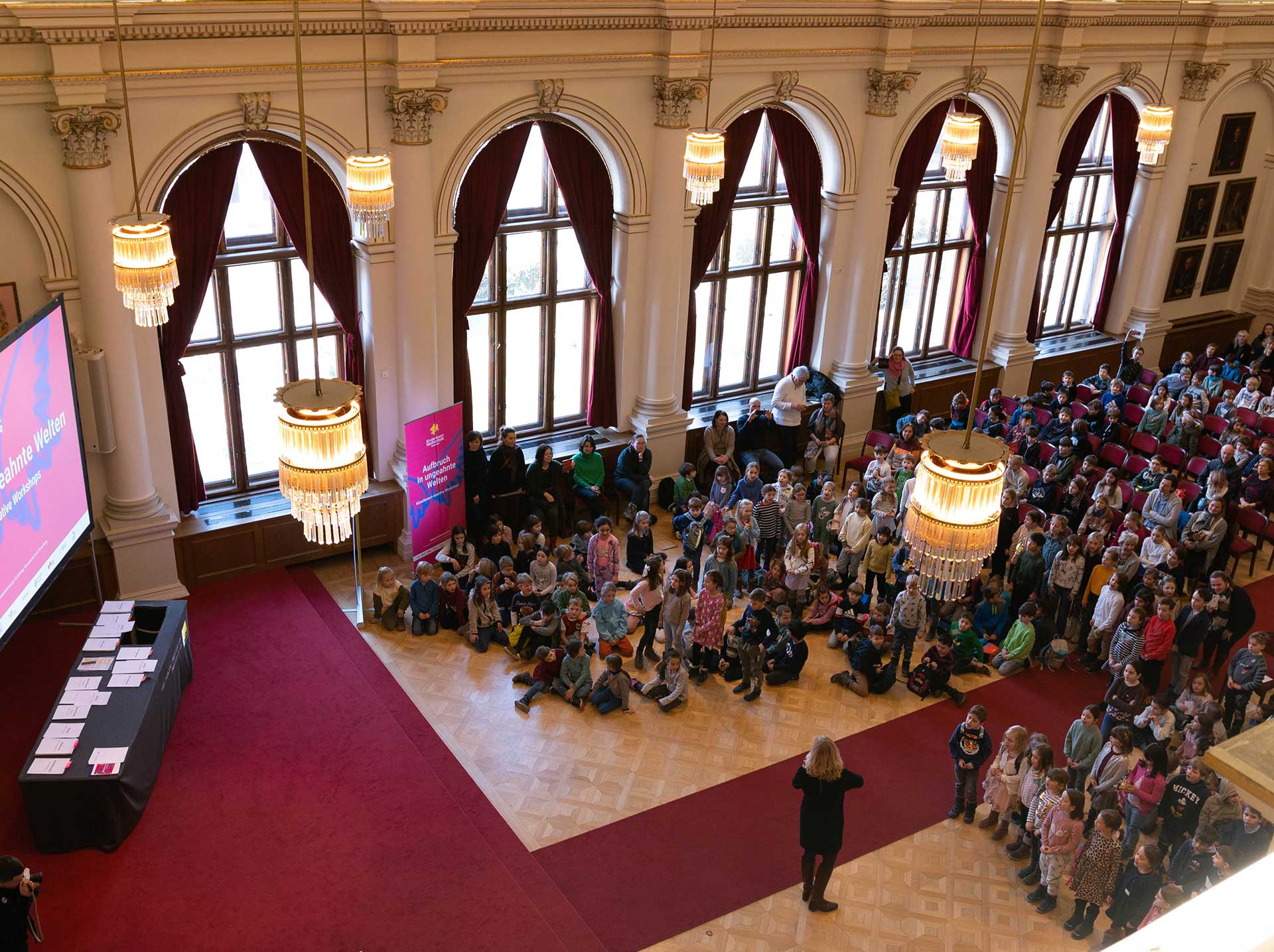 Viele Kinder in der Aula der Uni Graz, fotografiert von oben, von der Galerie 